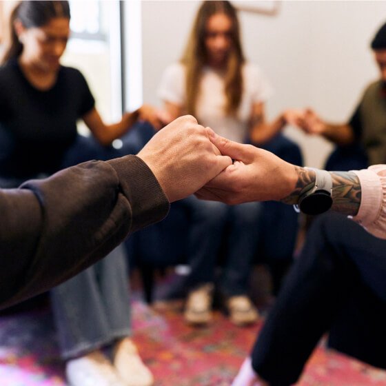 a group of people holding hands