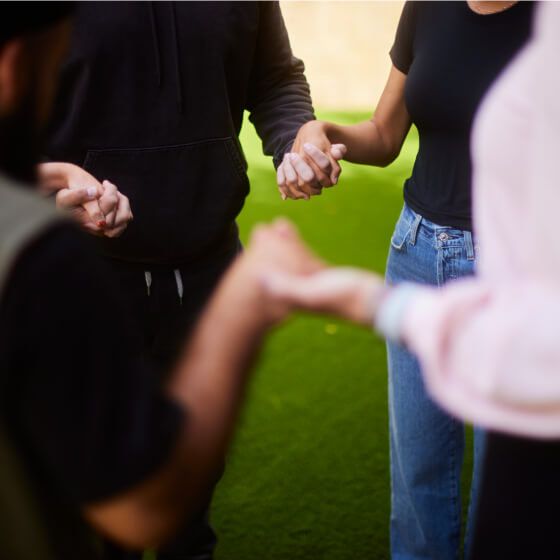 a group of people holding hands