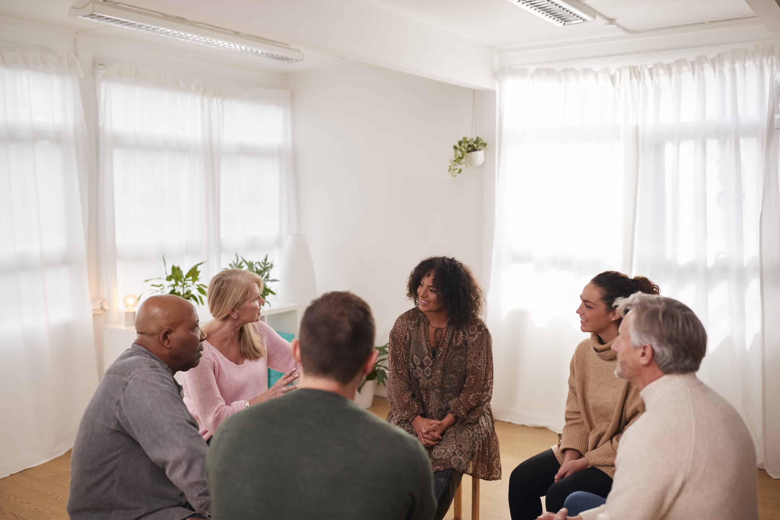 People Attending Support Group Meeting For Mental Health Or Dependency Issues In Community Space