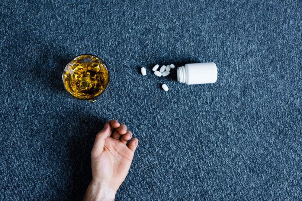 top view of male hand near container with pills ne 2026 03 25 10 46 18 utc scaled e1777297845635