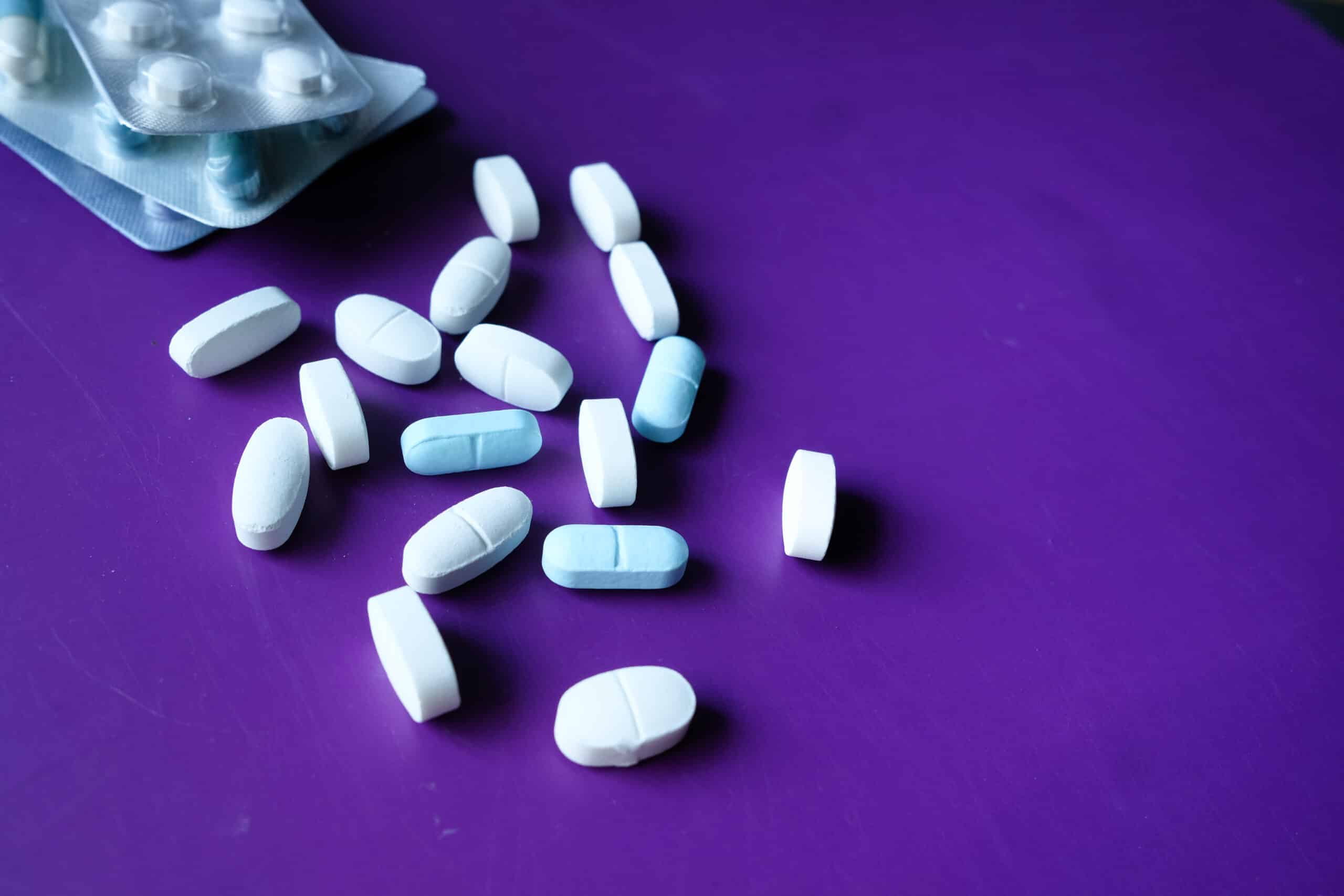 close up of pills spilling on purple desk 2026 03 16 03 23 15 utc scaled