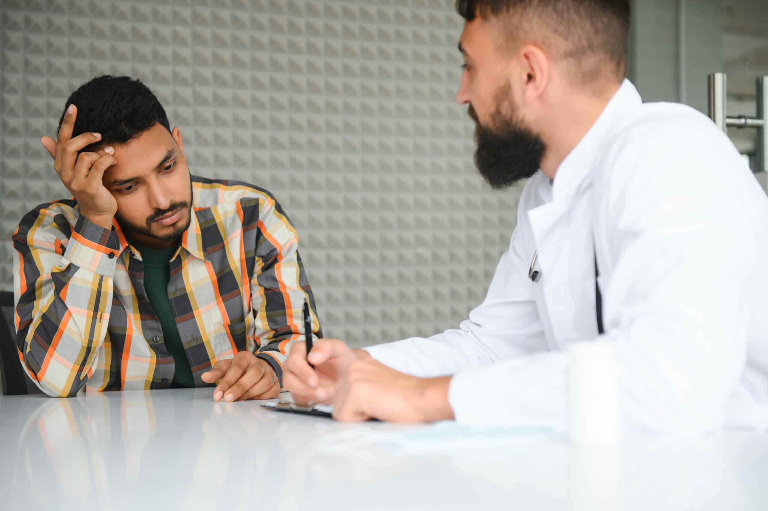 A man talking to a doctor looking stressed wondering how long does crystal meth stay in your system.