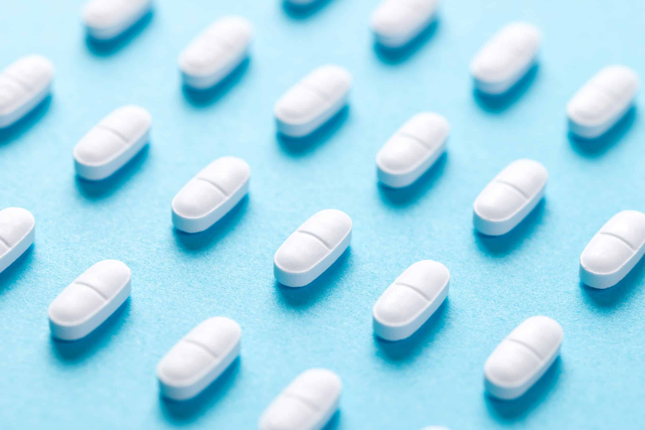 white pills on blue background in macro 2026 03 16 03 30 45 utc scaled